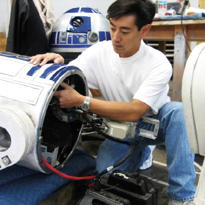 Grant Imahara works on an R2-D2 unit